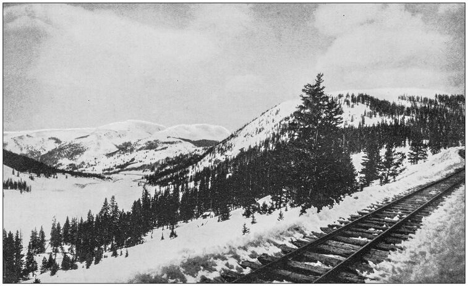 antique photo of snowy American mountains and railroad