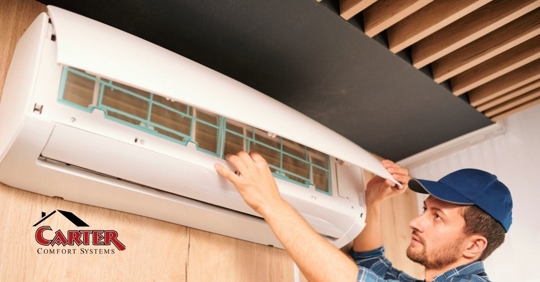 An HVAC technician repairing an AC unit.