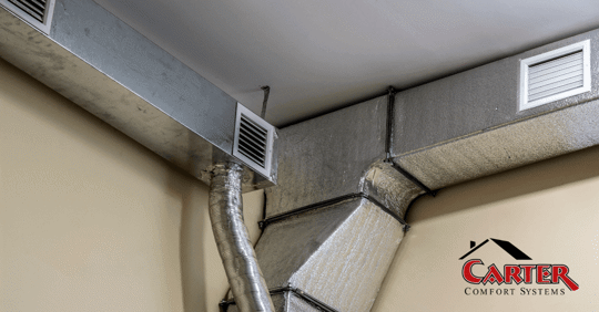 A heating duct in the corner of a room.