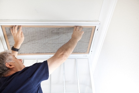 Man Checking Dirty Air Filter