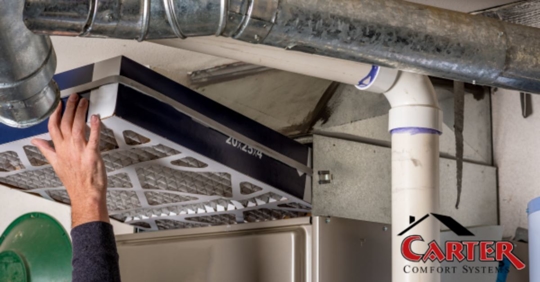 Seasonal maintenance being performed on a home's furnace.